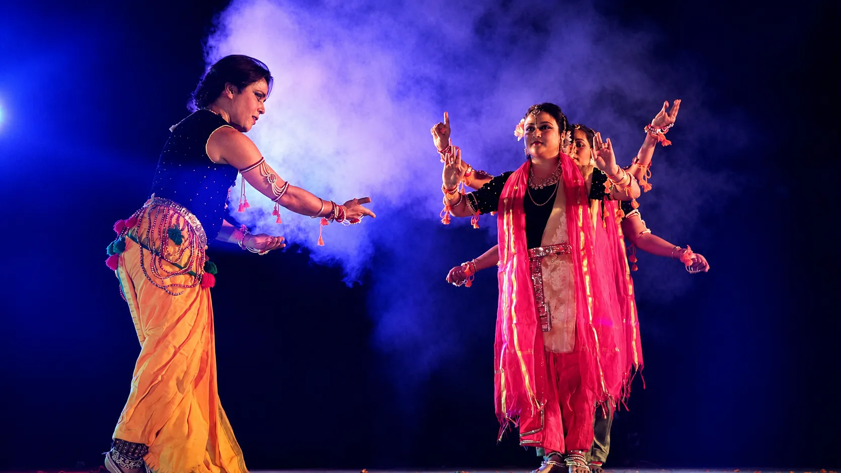 A Manipuri duet under blue light with drifting stage smoke